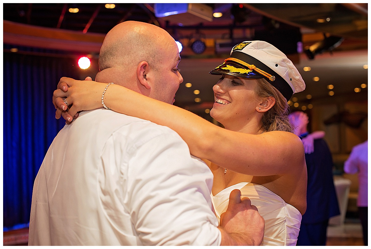 bride and groom dancing at wedding reception, bride is wearing captans hat, , Destination wedding photography by Bokeh Love Photography