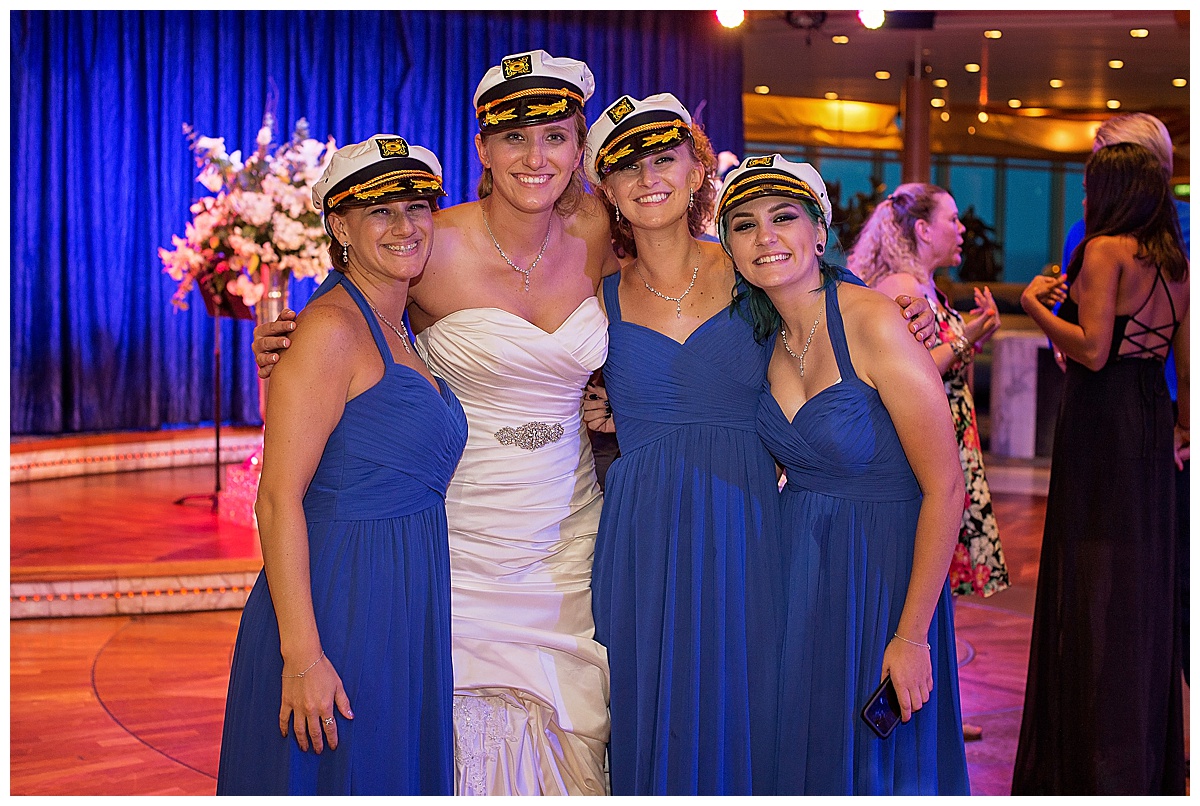 bride and bridesmaids at wedding reception wearing blue bridesmaids gowns and captains hats, , Destination wedding photography by Bokeh Love Photography