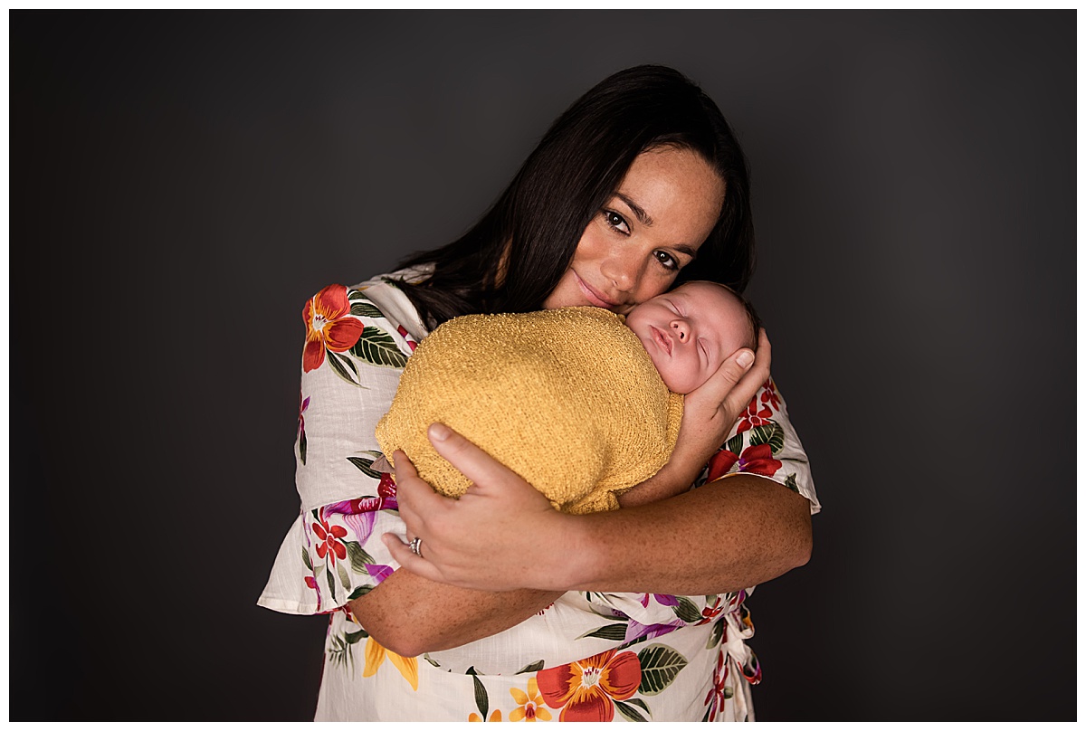 Newborn Session with Family Portraits before session. Beautiful baby boy in a yellow wrap, with mom , Photographs by Bokeh Love Photography.