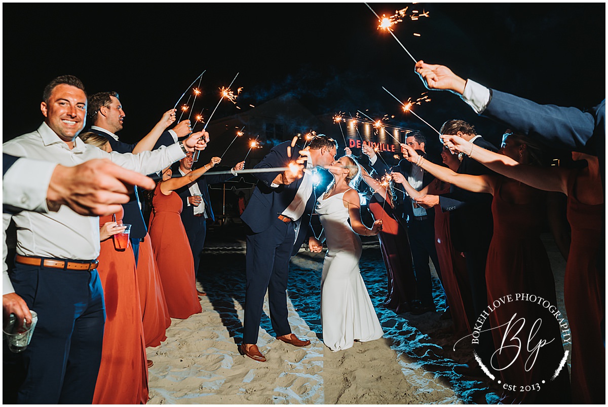 Wedding Photography by Bokeh Love Photography, end of night image with bride and groom running through sparklers