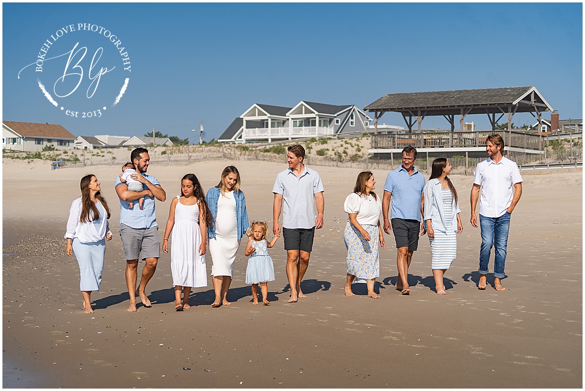 Family on beach wearing light blue and white clothing in Beach Haven NJ