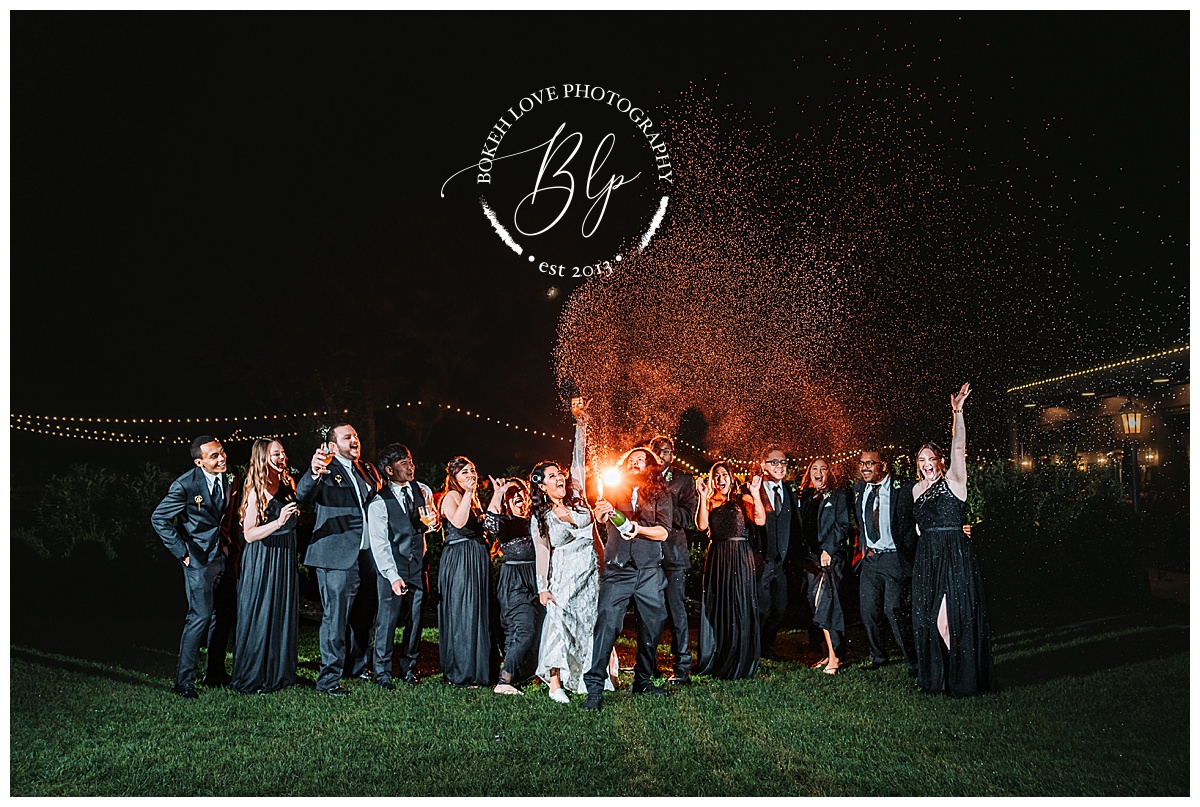 Champagne spray night photo at Renault Winery. Photo by Bokeh Love Photography. October Wedding. 