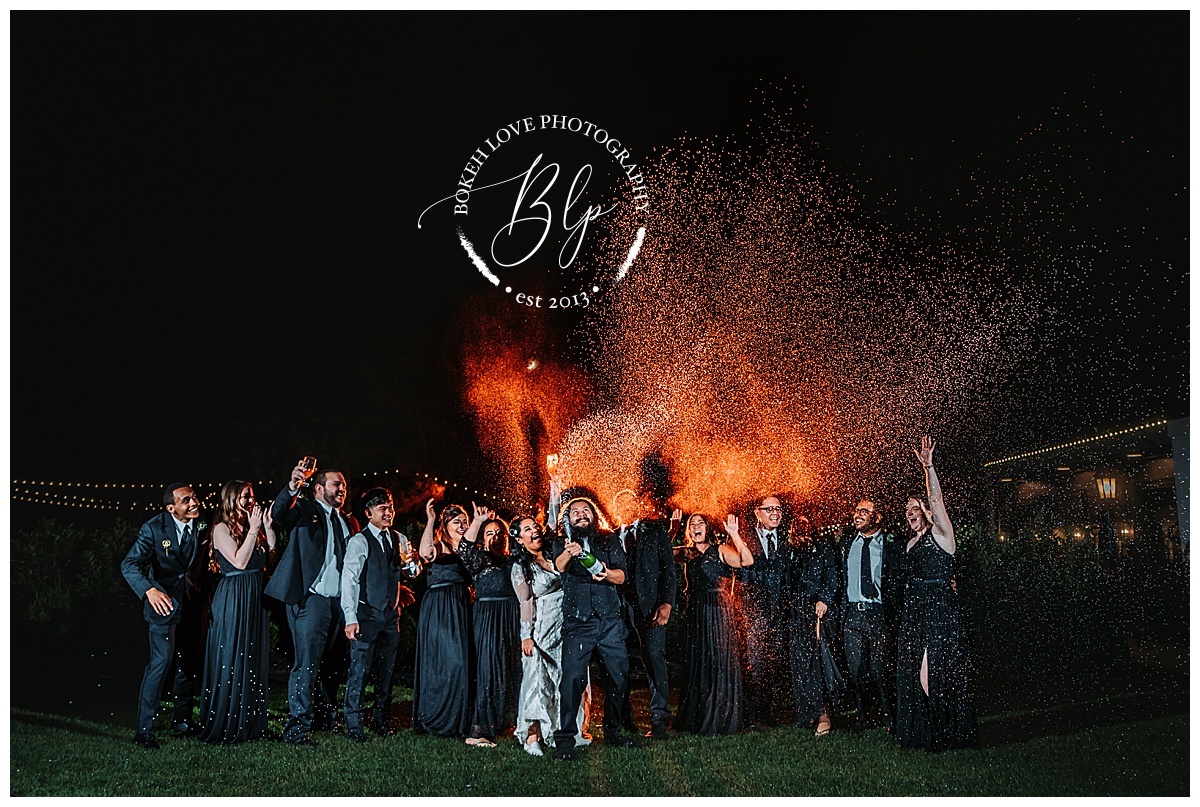Champagne spray night photo at Renault Winery. Photo by Bokeh Love Photography. October Wedding. 