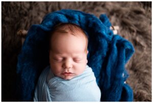Newborn Session with Family Portraits before session. Beautiful baby boy in a blue wrap, Photographs by Bokeh Love Photography.