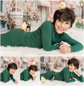 Boy wearing green pajamas laughing at professional portrait session with baby chicks